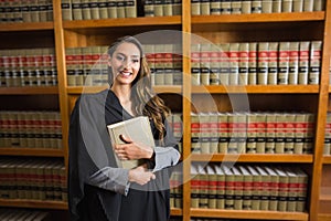 Pretty lawyer looking at camera in the law library