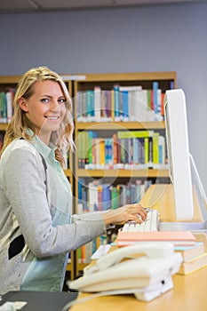 Pretty librarian working in the library