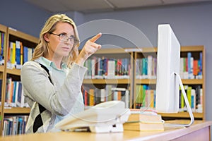 Pretty librarian working in the library