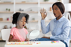 Pretty little black girl attending speech therapy session