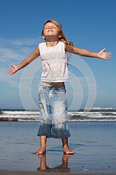 Pretty little girl on the beach photo