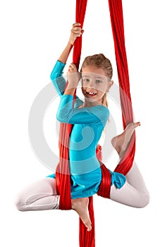 Pretty little girl in a blue gymnastic suit