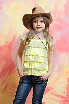 Pretty little girl with cute face in western cowboy hat