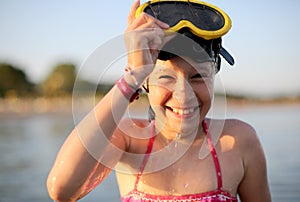 Pretty little girl with diving mask at the sea