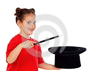 Pretty little girl doing magic with a top hat and a magic wand