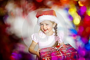 Pretty little girl dressed in santa red hat, new year portrait w