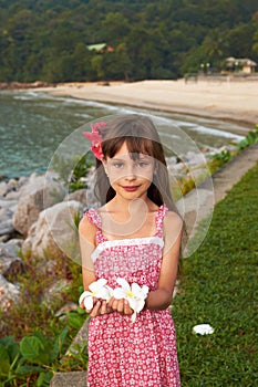 A Pretty Little Girl with Flowers in Her Hands