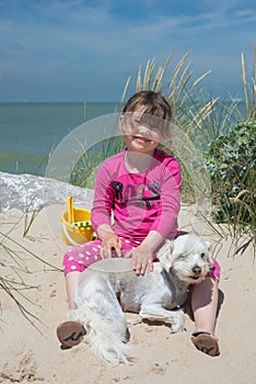 Pretty little girl making sandcastles on the beaches of Hauts-de-France