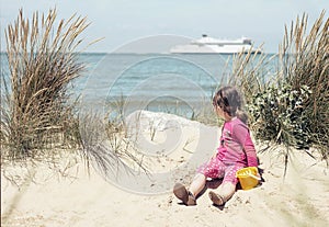 Pretty little girl making sandcastles on the beaches of Hauts-de-France