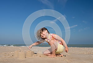 Pretty little girl making sandcastles on the beaches of Hauts-de-France