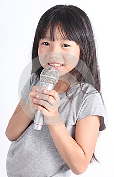 Pretty little girl with the microphone in her hand