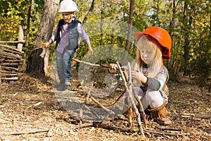 Pretty little girl playing at being a builder