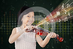 Pretty little girl playing violin