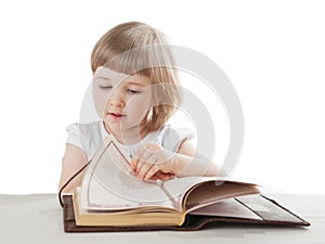 Pretty little girl reading an interesting book