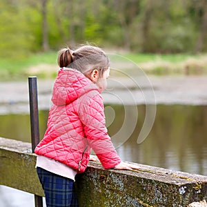 Pretty little girl relax at beauty summer landscape background