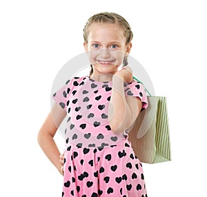 Pretty little girl with shopping bag, studio portrait, dressed in pink with heart shapes, white background