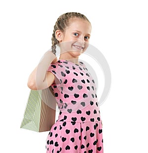 Pretty little girl with shopping bag, studio portrait, dressed in pink with heart shapes, white background