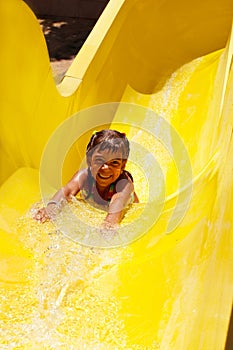 Pretty little girl sliding in aquapark