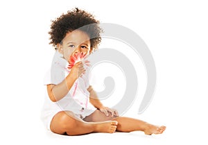 Pretty little girl smelling a flower