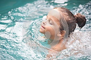 Pretty little girl in swimming pool