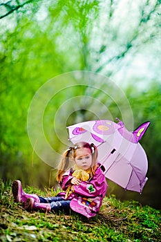 Pretty little girl with umbrella in the park