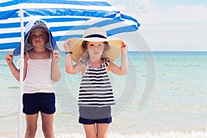 Pretty little girls (sisters) on the beach.