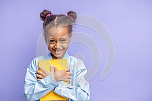 Pretty little mulatto child with book isolated