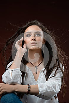 Pretty long brown hair girl model wearing luxury silver accessory and jewelry. Woman Isolated on brown background