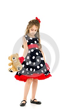 Pretty Long Haired Girl Wearing Polka Dot Dress Posing with Teddy Bear