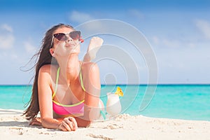 pretty longhaired woman with delicious pina colada cocktail by the beach. Maldives