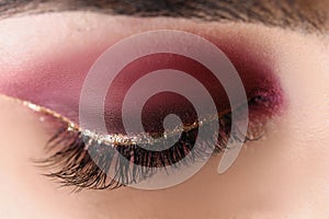 Pretty makeup on woman face, red autumn colours