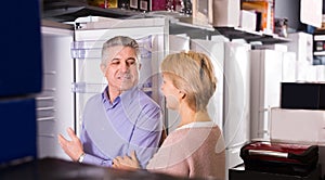 Pretty mature married couple choose for themselves refrigerator