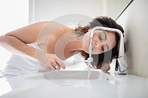 Pretty, middle aged woman brushing her teeth