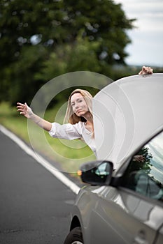 Pretty middle aged woman having car troubles