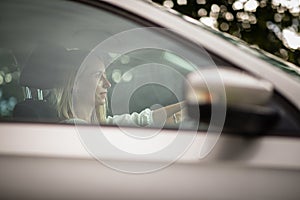 Pretty middle aged woman at the steering wheel