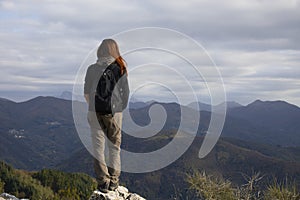 Pretty middle aged woman on top of a mountain
