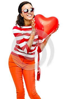 Pretty mixed race girl holding red heart balloon