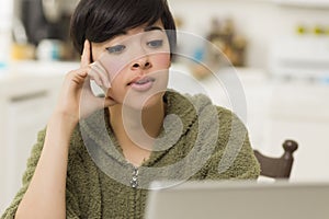 Pretty Mixed Race Teen Using Laptop at Home