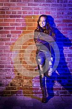 Pretty Mixed Race Young Adult Woman Against a Brick Wall