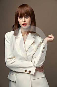 Pretty model in beige jacket gesticulate with hands