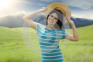 Pretty model with hat smiling at field