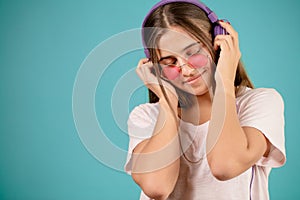 Pretty model with long brown hair is enjoying the music