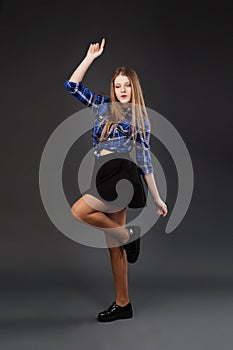 Pretty modern slim hip-hop style teenage girl jumping dancing on