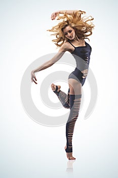 Pretty modern woman dancer on blue background