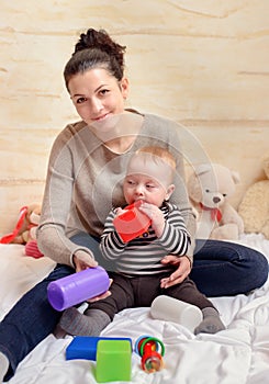 Pretty Mom with her Baby Boy Smiling at Camera