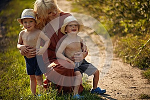 Pretty mother hugging her beloved sons