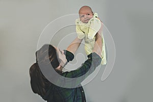 Pretty mother lifts her baby up