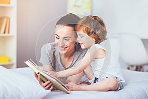 Pretty mother reading a book to her lovely son