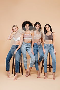 pretty multiethnic women in jeans and