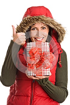 Pretty mum holding gift giving thumbs up